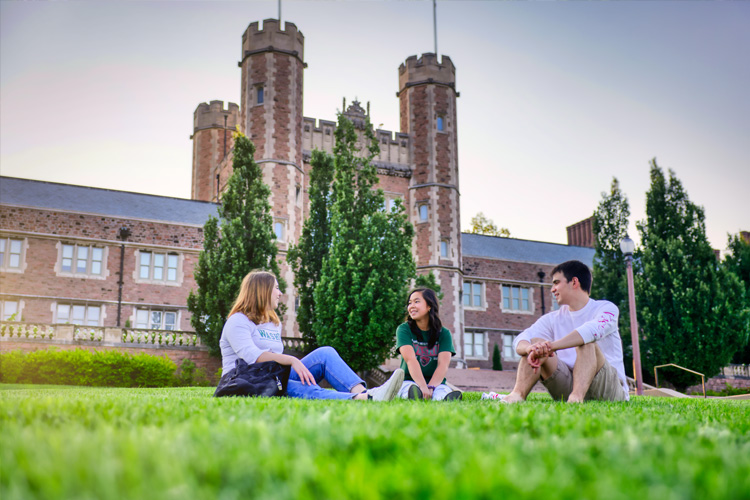 students sitting and talking near Brookings Hall